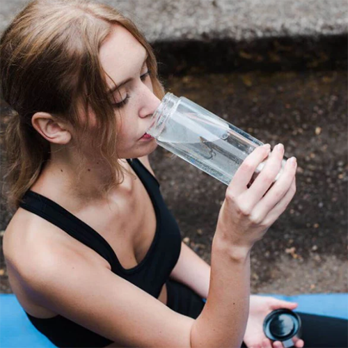 Woman drinking out of the LifeWater bottle